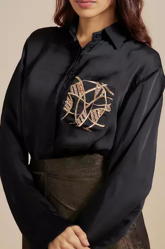 Black embroidered shirt with black skirt