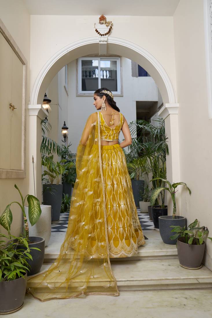 Glamorous Mustard Yellow Butterfly Net With Tone To Tone Thread And Sequence Embroidered Work Lehenga Choli For Wedding