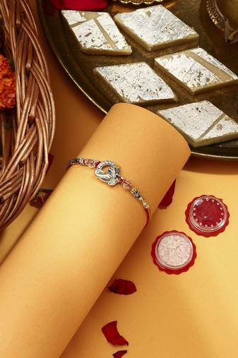 Silver Plated Pecaock Thread Rakhi with Kumkum & Chawal
