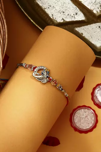 Silver Plated Pecaock Thread Rakhi with Kumkum & Chawal