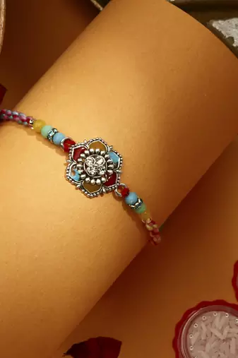 Multicolour Flower Shaped Thread Rakhi with Kumkum & Chawal