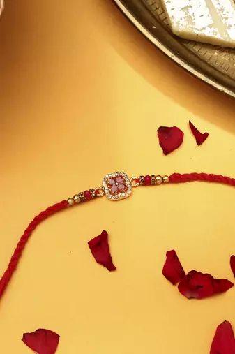 Red flower shaped with american stone studded rakhi
