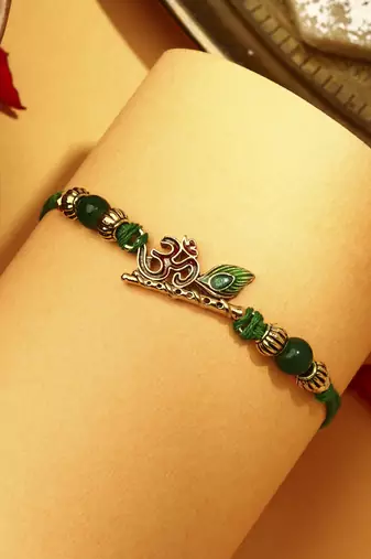Om with flute & peacock feature rakhi