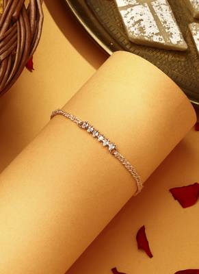 American stone studded rakhi with peach thread 1