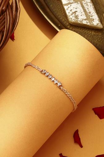 American stone studded rakhi with peach thread