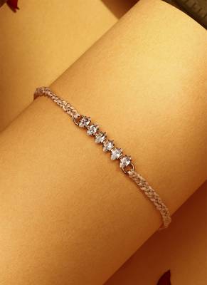 American stone studded rakhi with peach thread 2
