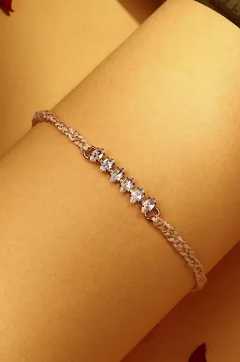 American stone studded rakhi with peach thread
