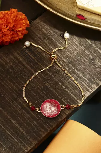 Elegant pink rakhi with golden lotus painted bhaiya bhabhi set