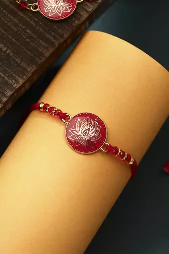 Elegant pink rakhi with golden lotus painted bhaiya bhabhi set