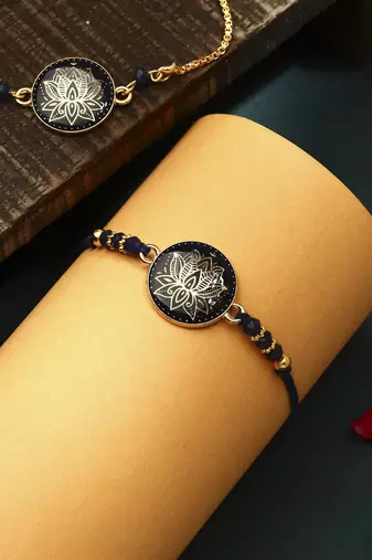 Elegant blue rakhi with golden lotus painted bhaiya bhabhi set