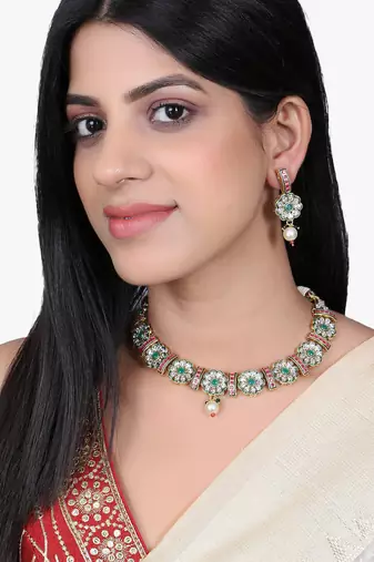 Women gold plated stone studded pearl tessel necklace and earrings