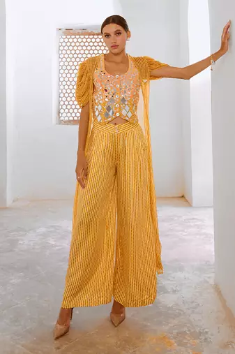 Marigold yellow tussar silk sheesha koti with chiffon jacket and loose pant set.