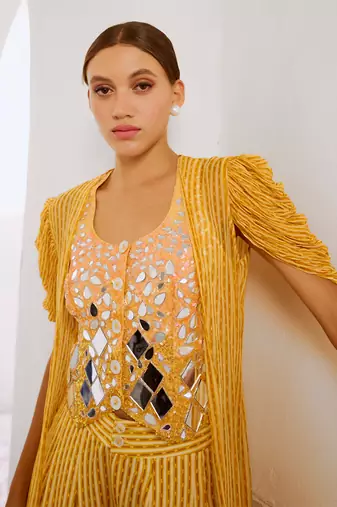 Marigold yellow tussar silk sheesha koti with chiffon jacket and loose pant set.
