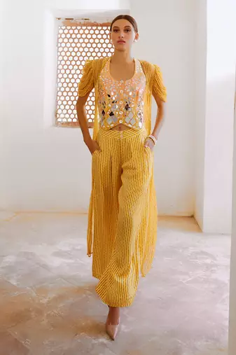 Marigold yellow tussar silk sheesha koti with chiffon jacket and loose pant set.