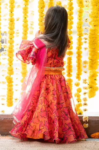 Orange and pink organza printed floral lehenga with one-shoulder blouse
