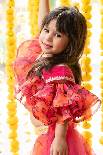 Orange and pink organza printed floral lehenga with one-shoulder blouse