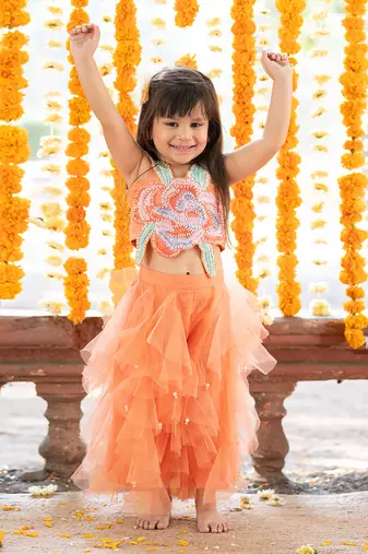 Orange net embroidered sequin frilled lehenga with floral cutwork crop top