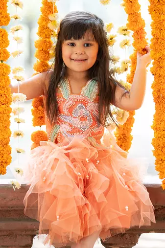 Orange net embroidered sequin frilled lehenga with floral cutwork crop top