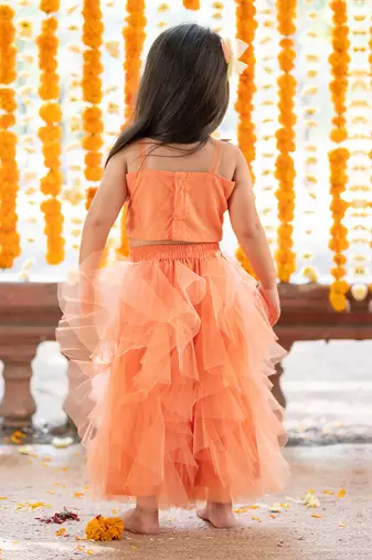 Orange net embroidered sequin frilled lehenga with floral cutwork crop top