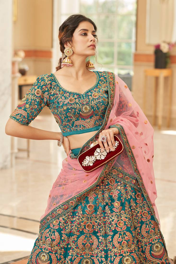 Alluring Teal Blue Thread Zari Dori And Sequins Embroidered Velvet Bridal Wear Lehenga Choli For Women