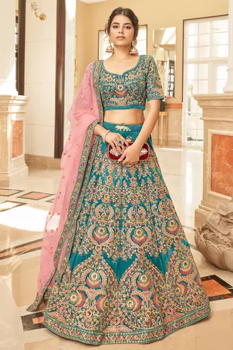 Alluring Teal Blue Thread Zari Dori And Sequins Embroidered Velvet Bridal Wear Lehenga Choli For Women