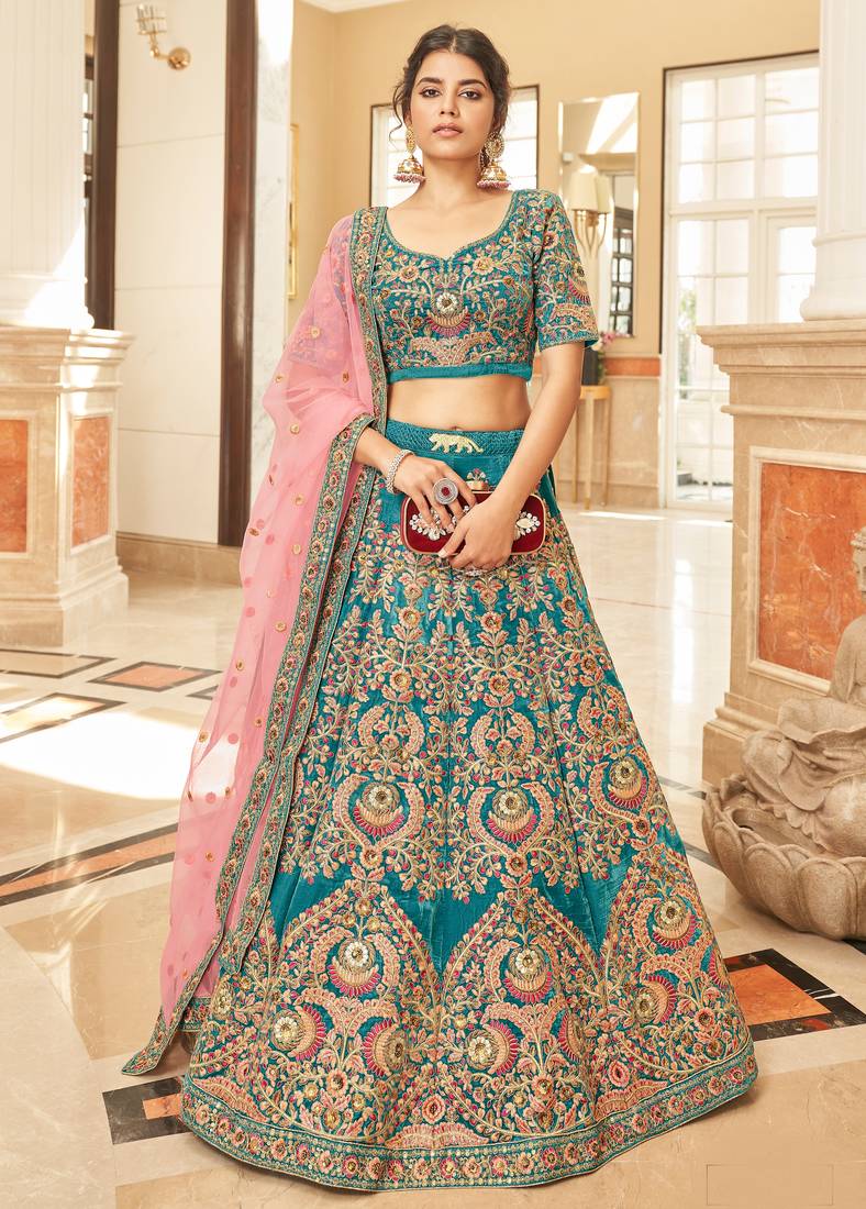 Alluring Teal Blue Thread Zari Dori And Sequins Embroidered Velvet Bridal Wear Lehenga Choli For Women