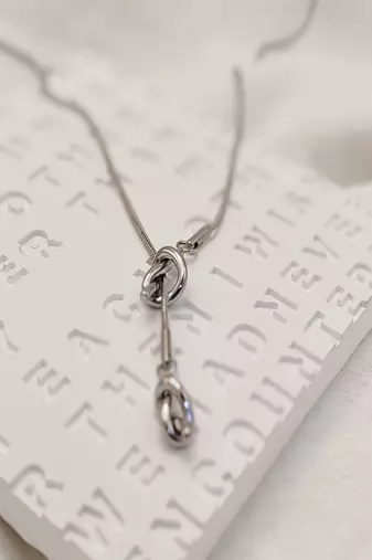 Silver plated tassel knot necklace