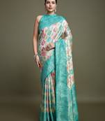 Glamour And Tradition With This Zari Woven Turquoise And Cream Banarasi silk blend Saree