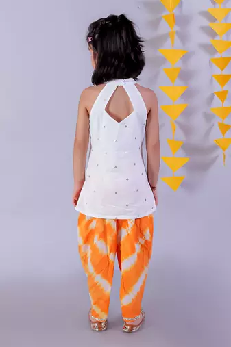 white girls cotton kurta and orange dhoti ethnic set