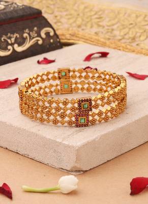 Whimsical Elegance: Gold-Plated Bangles with Delicate Shapes and Floral Accents 1