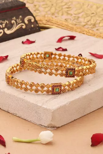 Whimsical Elegance: Gold-Plated Bangles with Delicate Shapes and Floral Accents