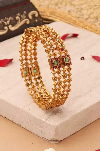 Whimsical Elegance: Gold-Plated Bangles with Delicate Shapes and Floral Accents