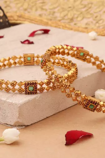 Whimsical Elegance: Gold-Plated Bangles with Delicate Shapes and Floral Accents