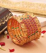 Goddess Radiance: Broad Gold-Plated Bangle with Intricate Motif and Gemstone Accents