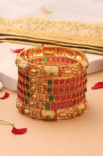 Goddess Radiance: Broad Gold-Plated Bangle with Intricate Motif and Gemstone Accents
