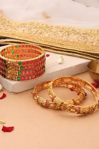 Goddess Radiance: Broad Gold-Plated Bangle with Intricate Motif and Gemstone Accents