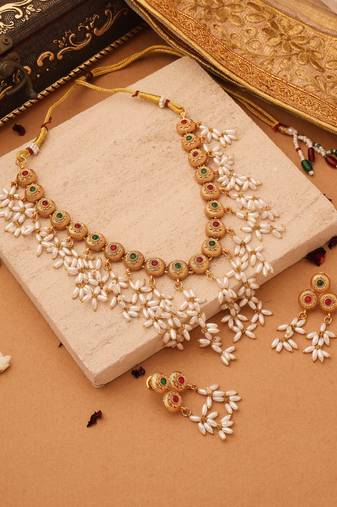 Radiant Reverie: Gold Cup Necklace with Red Stones and White Oval Jhumkis