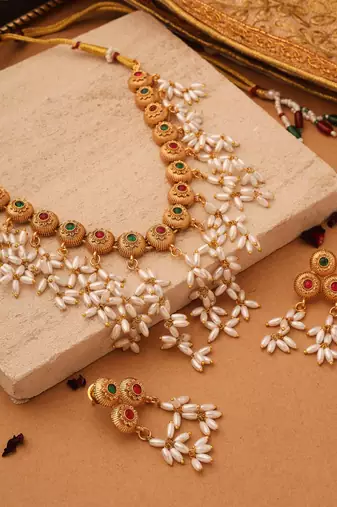 Radiant Reverie: Gold Cup Necklace with Red Stones and White Oval Jhumkis