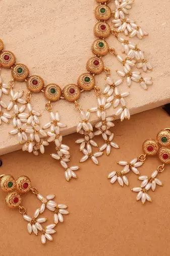 Radiant Reverie: Gold Cup Necklace with Red Stones and White Oval Jhumkis