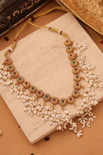 Radiant Reverie: Gold Cup Necklace with Red Stones and White Oval Jhumkis