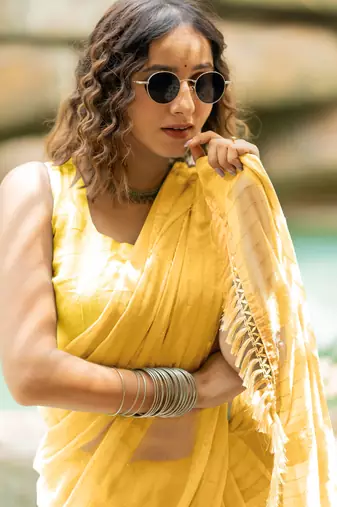 Light yellow georgette solid/ tassels golden zari woven border saree with unstitched blouse piece