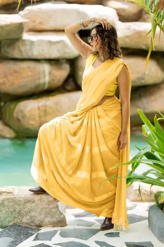 Light yellow georgette solid/ tassels golden zari woven border saree with unstitched blouse piece