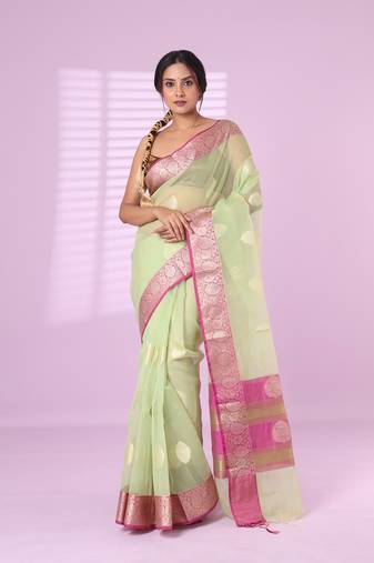 Pistachio green organza saree with zari weave border