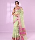 Pistachio green organza saree with zari weave border