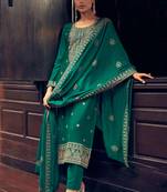 Turquoise embroidered silk semi stitched straight pant suit.