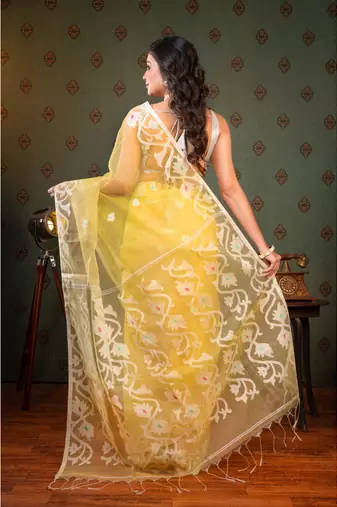 Light yellow  muslin saree offwhite woven motifs with running blouse piece