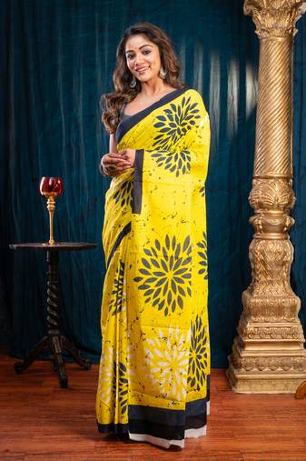 Yellow pure bagru malmal cotton saree with floral motifs and black borderwith running blouse piece
