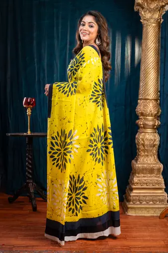 Yellow  bagru malmal cotton saree with floral motifs and black borderwith running blouse piece