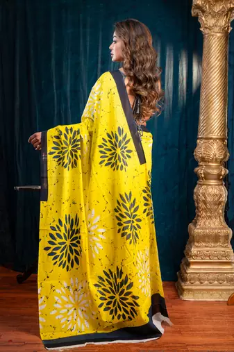 Yellow  bagru malmal cotton saree with floral motifs and black borderwith running blouse piece