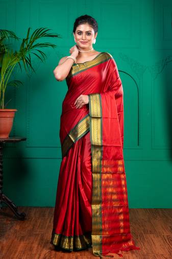 Red aura silk saree with contrasting green and golden zari borderwith running blouse piece